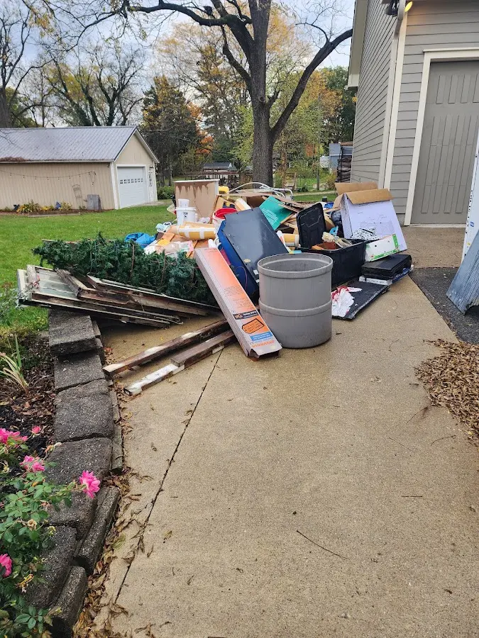 Dumpster being loaded with debris for Estate Cleanout Dumpster Rental in Gardendale